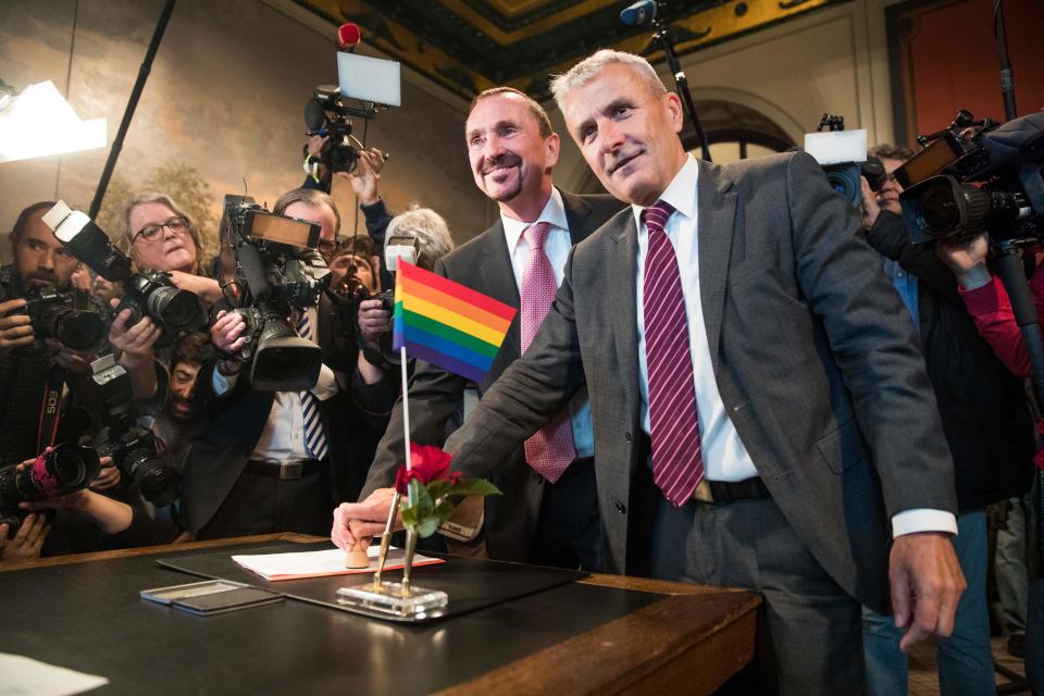 Bode Mende (R) and Karl Kreile stamp their marriage certificate as they  became Germany's first gay couple to be legally married tying the knot at the Schoeneberg town hall in Berlin on October 1, 2017.. Germany celebrates its first gay marriages as same-sex unions become legal after decades of struggle. Local authorities rushed to get weddings underway as soon as possible, after lawmakers voted on June 30th to give Germany's roughly 94,000 same-sex couples the right to marry.  / AFP PHOTO / Odd ANDERSEN        (Photo credit should read ODD ANDERSEN/AFP/Getty Images)