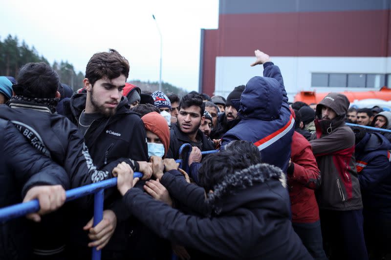 Migrants gather to receive food near the Belarusian-Polish border in the Grodno region