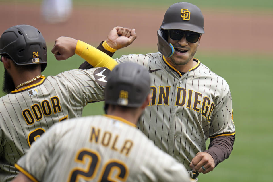 San Diego Padres' Trent Grisham, right, celebrates as he crosses home plate after hitting a two-run home run off Pittsburgh Pirates starting pitcher Luis Ortiz during the second inning of a baseball game in Pittsburgh, Thursday, June 29, 2023. (AP Photo/Gene J. Puskar)
