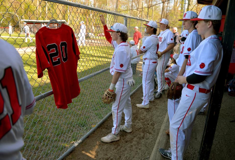 The Holliston High School baseball team hangs a No. 20 jersey in honor of Holliston alum Corey Ciarcello (‘09) who died on Feb. 28, here at their game against Dover-Sherborn, May 11.