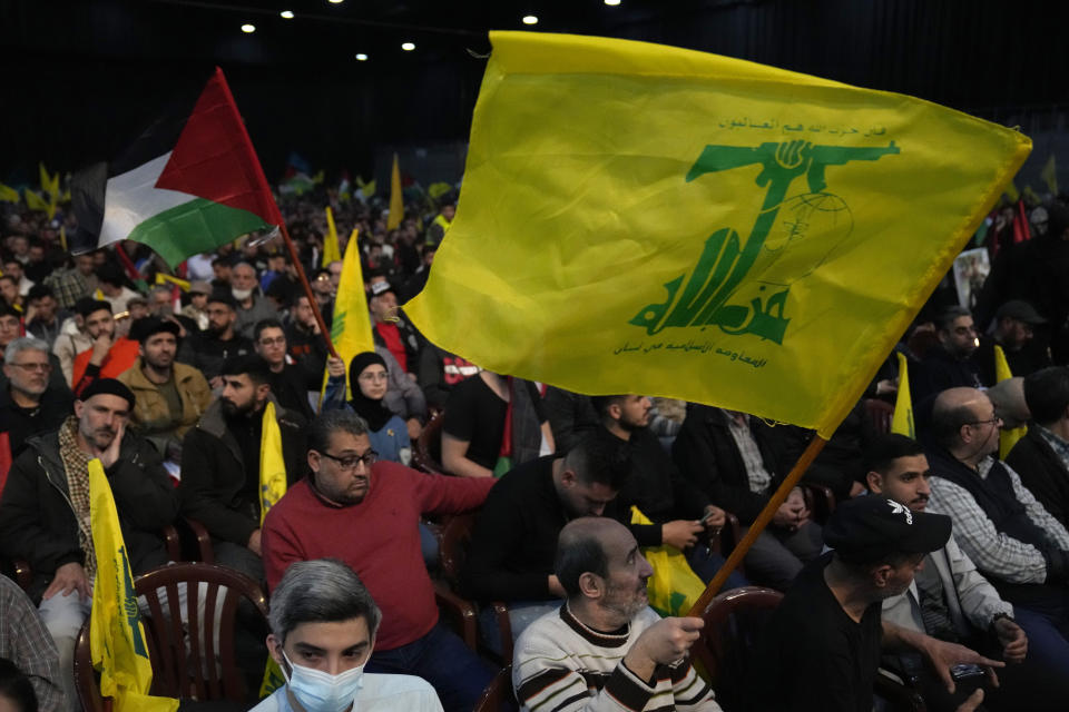 Hezbollah supporters wave their group and Palestinian flags, during a rally to mark Jerusalem day, in a southern suburb of Beirut, Lebanon, Friday, April 14, 2023. Since Iran's Islamic Revolution in 1979, the rallies marking what is also known as al-Quds Day have typically been held on the last Friday of the Muslim holy month of Ramadan. (AP Photo/Hussein Malla)