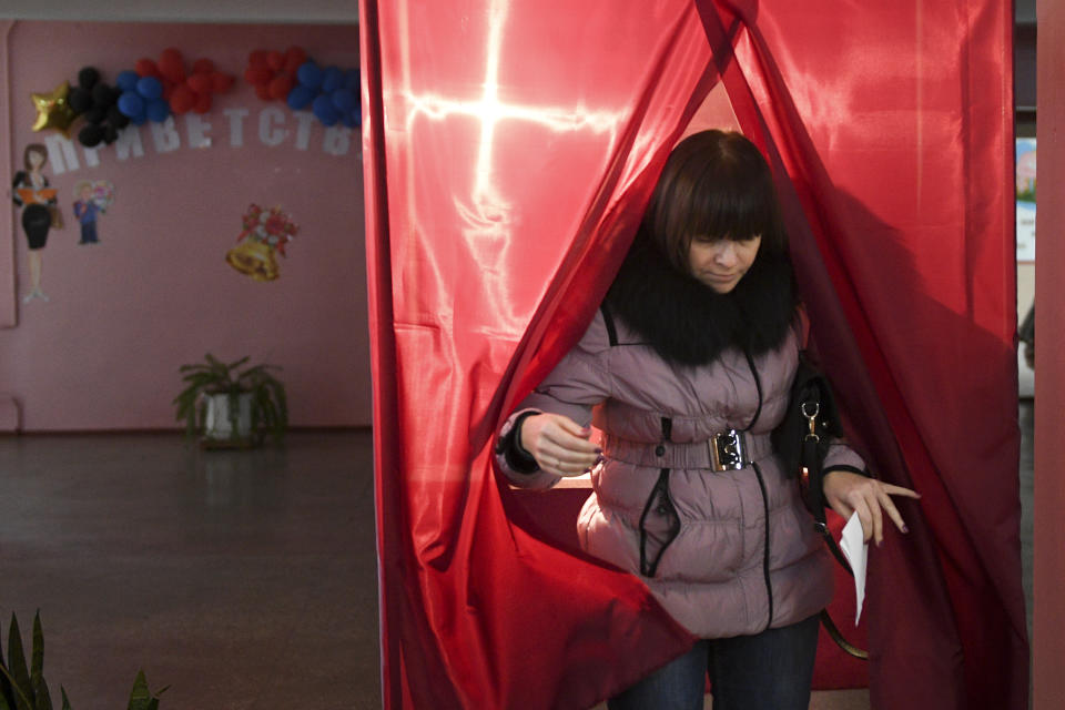 A woman exits a polling booth during rebel elections in Donetsk, Ukraine, Sunday, Nov. 11, 2018. Residents of the eastern Ukraine regions controlled by Russia-backed separatist rebels are voting for local governments in elections denounced by Kiev and the West. (AP Photo)