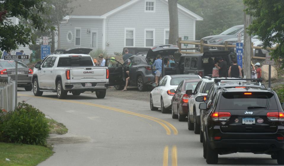 Traffic lines up along Horsefoot Path near the intersection with Coolidge Way with cars waiting to drop off beachgoers heading to Mayflower Beach in Dennis. The parking lot was full by early morning on Wednesday despite the fog. Beach traffic is a major headache for neighbors of the popular beach.