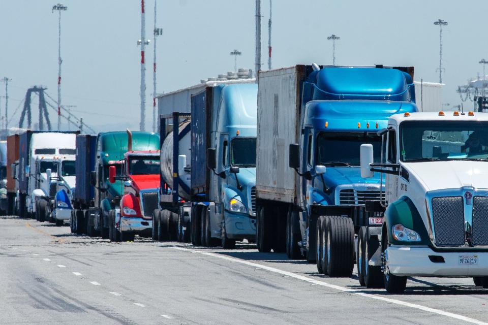 Shipping trucks leave the Port of Oakland on Wednesday in Oakland, California. (Kate Munsch for HuffPost)