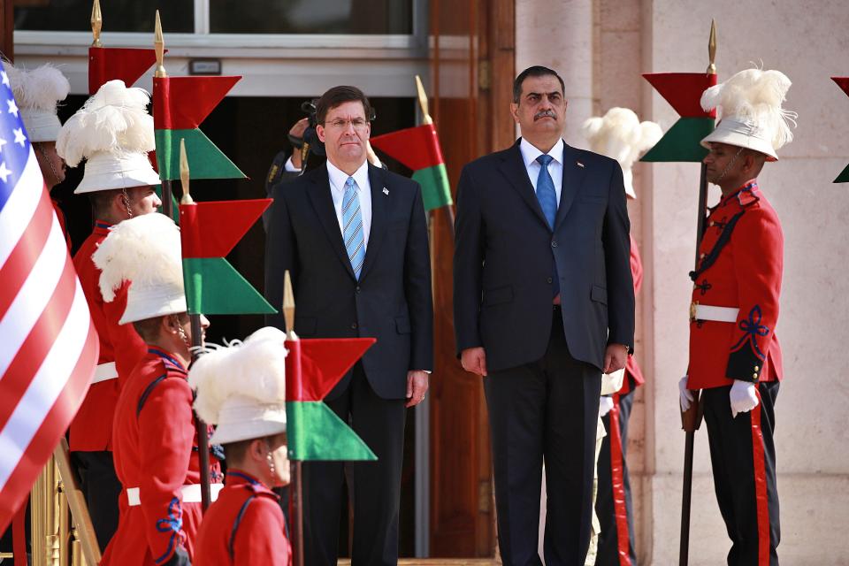 Iraqi Defense Minister Najah al-Shammari, center right, and U.S. Defense Secretary Mark Esper, center left, stand for their country's national anthems during a welcome ceremony at the Ministry of Defense, Baghdad, Iraq, Wednesday, Oct. 23, 2019. Esper has arrived in Baghdad on a visit aimed at working out details about the future of American troops that are withdrawing from Syria to neighboring Iraq. (AP Photo/Hadi Mizban)