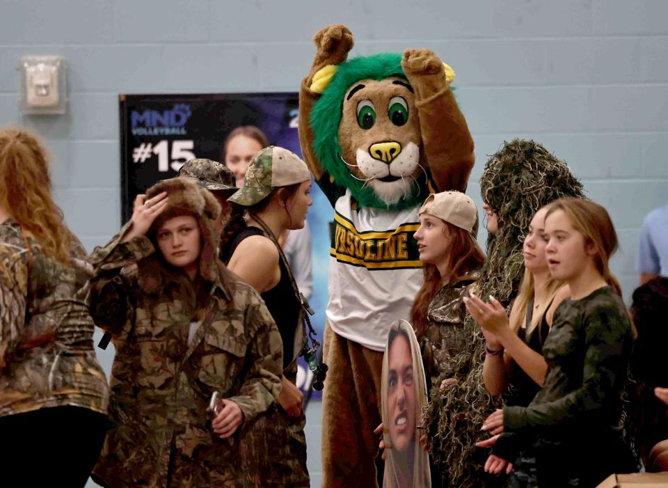The Ursuline Lion mascot cheers on the girls volleyball team as the girls played Mount Notre Dame Sept. 20.