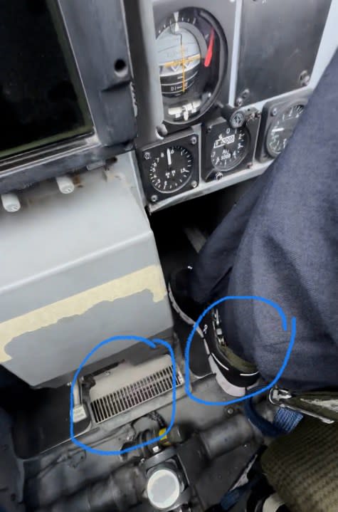 The planes have 3 vents in the passenger area which can provide cold air (helping with nausea). Also, one of the ankle straps is visible in this pic.