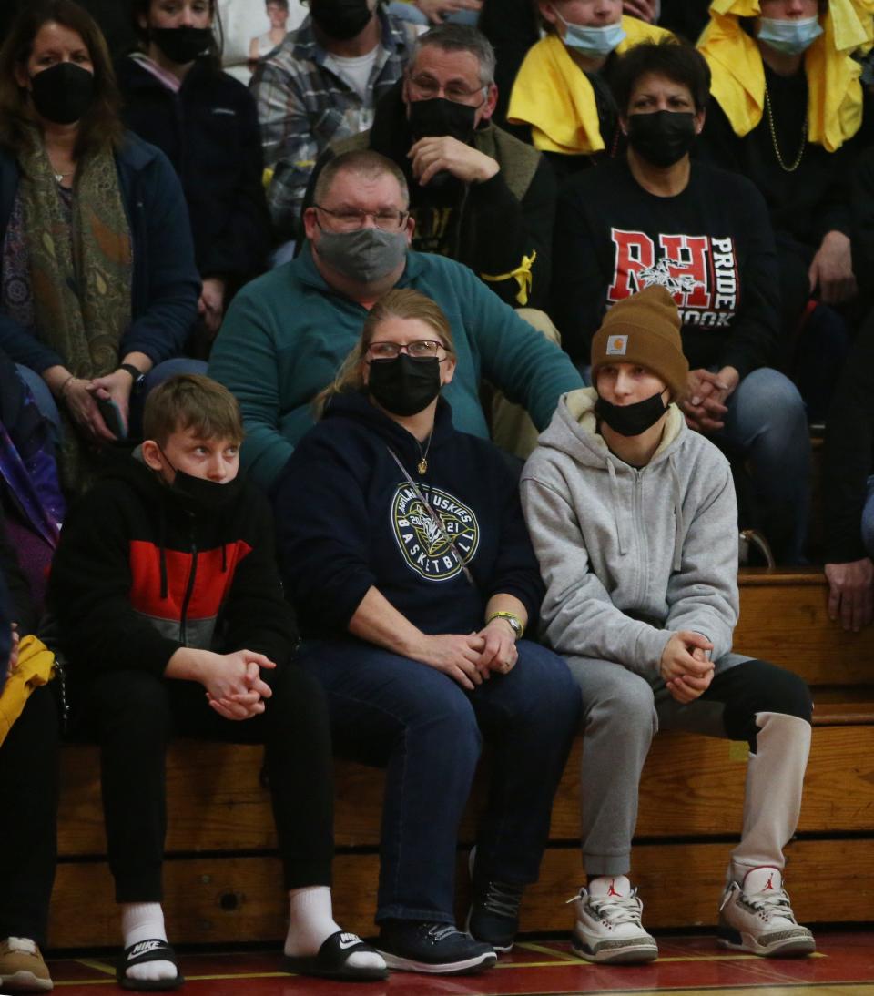 From left, Ben, Anne Marie, Reggie and Zach Osterhoudt watch the varsity boys basketball game between Highland and Red Hook on February 18, 2022.