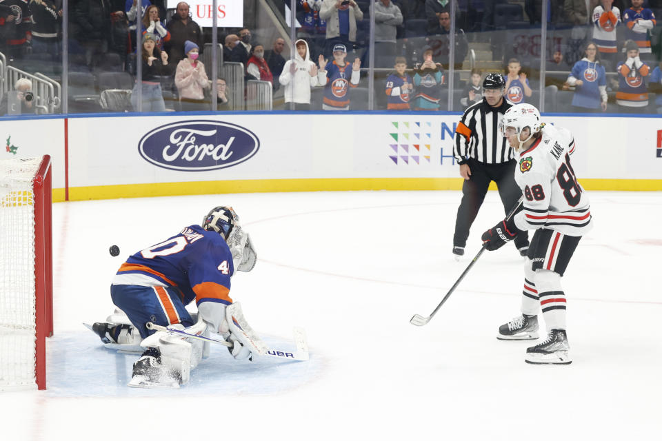 Chicago Blackhawks right wing Patrick Kane (88) scores the winning goal against New York Islanders goaltender Semyon Varlamov (40) during a shootout of an NHL hockey game, Sunday, Dec. 5, 2021, in Elmont, N.Y. (AP Photo/Corey Sipkin).