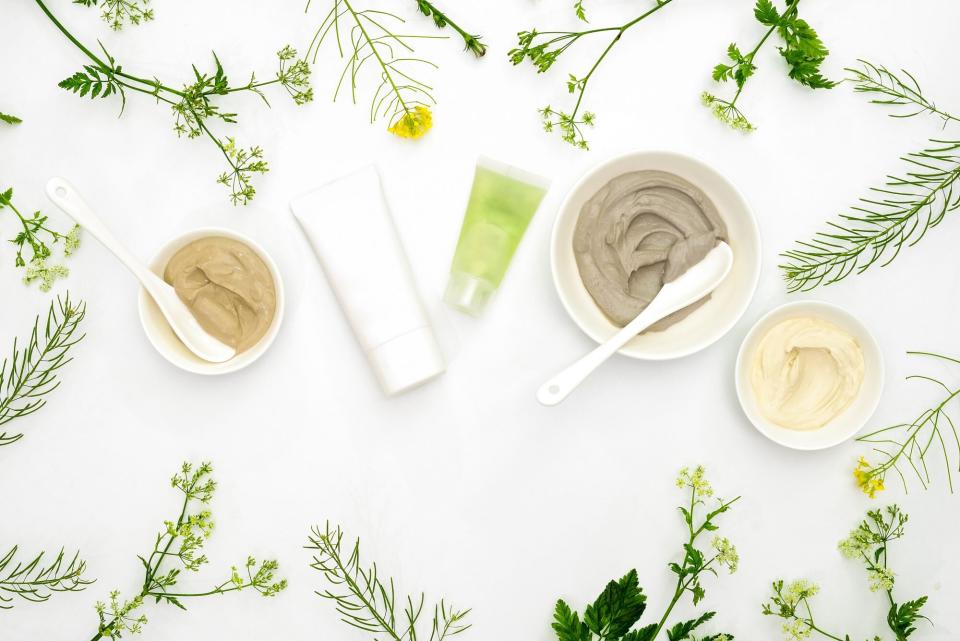 beauty products surrounded by greenery