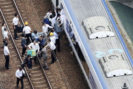 Passengers get off a train which operation was suspended after an earthquake in Takatsuki, Osaka prefecture, western Japan, in this photo taken by Kyodo June 18, 2018. Mandatory credit Kyodo/via REUTERS