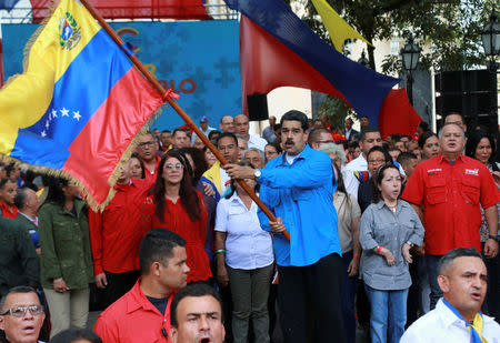 Venezuelan President Nicolas Maduro (C) waves the Venezuelan flag during an event with supporters in Caracas, Venezuela July 3, 2017. Miraflores Palace/Handout via REUTERS