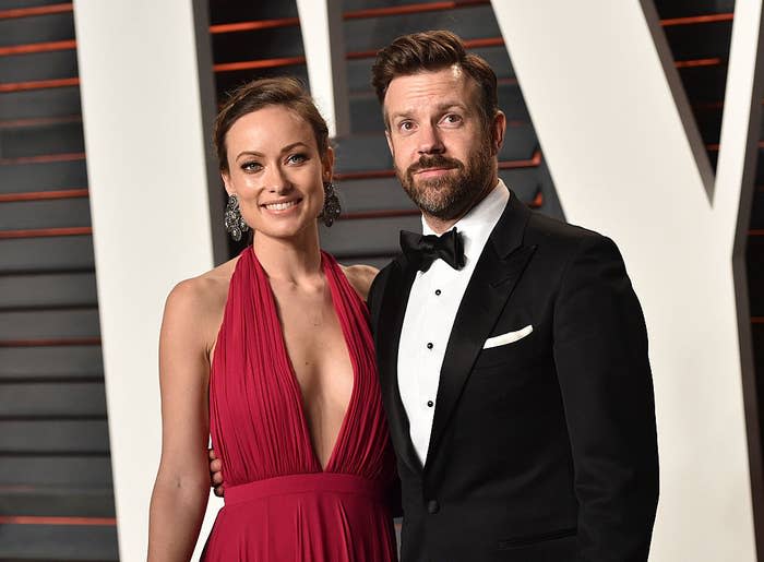 Olivia and Jason arm-in-arm at a red carpet event when they were still a couple