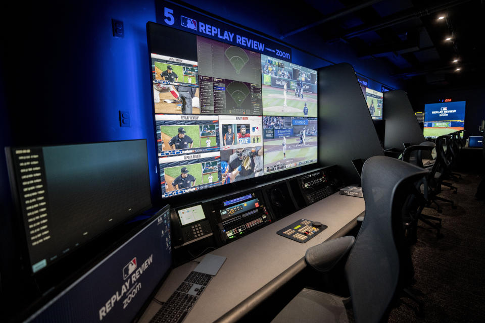 A Major League Baseball umpire is displayed alongside gameplay clips at a Replay Review station during a tour at MLB headquarters in New York, Tuesday, March 28, 2023. (AP Photo/John Minchillo)