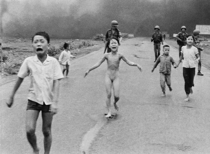 FILE - 9-year-old Kim Phuc, center, runs with her brothers and cousins, followed by South Vietnamese forces, down Route 1 near Trang Bang after a South Vietnamese plane accidentally dropped its flaming napalm on its own troops and civilians, June 8, 1972. The terrified girl had ripped off her burning clothes while fleeing. Known as the girl in the 1972 Vietnam napalm attack photo, Phan Thị Kim Phuc flew aboard an NGO plane from Warsaw on Monday accompanying almost 240 refugees from the war in Ukraine on a flight to safety in Canada. (AP Photo/Nick Ut, File)