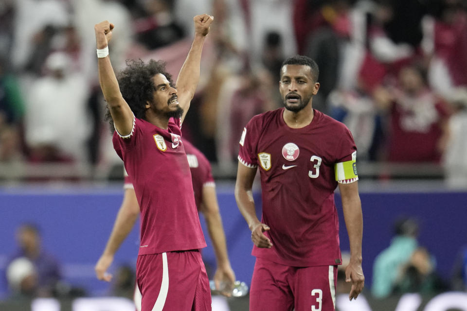 Qatar's Akram Afif, left, celebrates after scoring his side's second goal during the Asian Cup semifinal soccer match between Iran and Qatar at Al Thumama Stadium in Doha, Qatar, Wednesday, Feb. 7, 2024. (AP Photo/Aijaz Rahi)