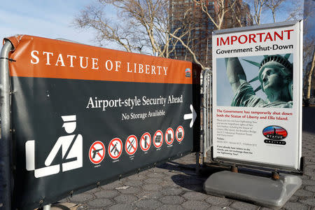 A sign announcing the closure of the Statue of Liberty, due to the U.S. government shutdown, sits near the ferry dock to the Statue of Liberty at Battery Park in Manhattan, New York, U.S., January 20, 2018. REUTERS/Andrew Kelly