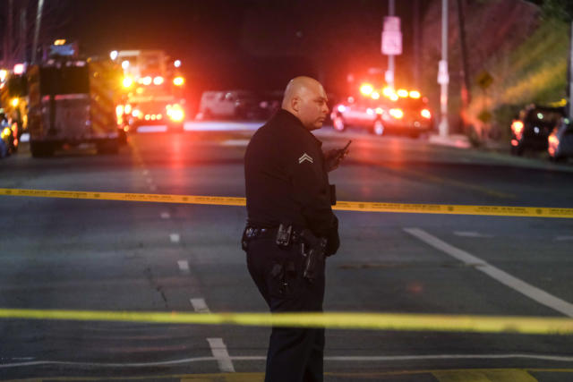 A police officer stands guard near a crime scene where three Los Angeles police officers were shot, Wednesday, March 8, 2023, in Los Angeles. Police said the officers were hospitalized and in stable condition. (AP Photo/Ringo H.W. Chiu)