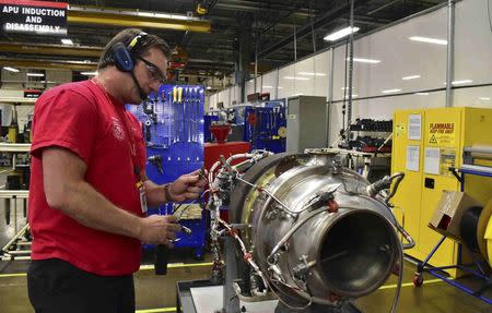 Mechanic Andrew Newingham uses a wireless headset and voice-controlled computer to quickly input details about an auxiliary power unit engine needing repairs at a Honeywell Aerospace service center in Phoenix, Arizona September 6, 2016. REUTERS/Alwyn Scott