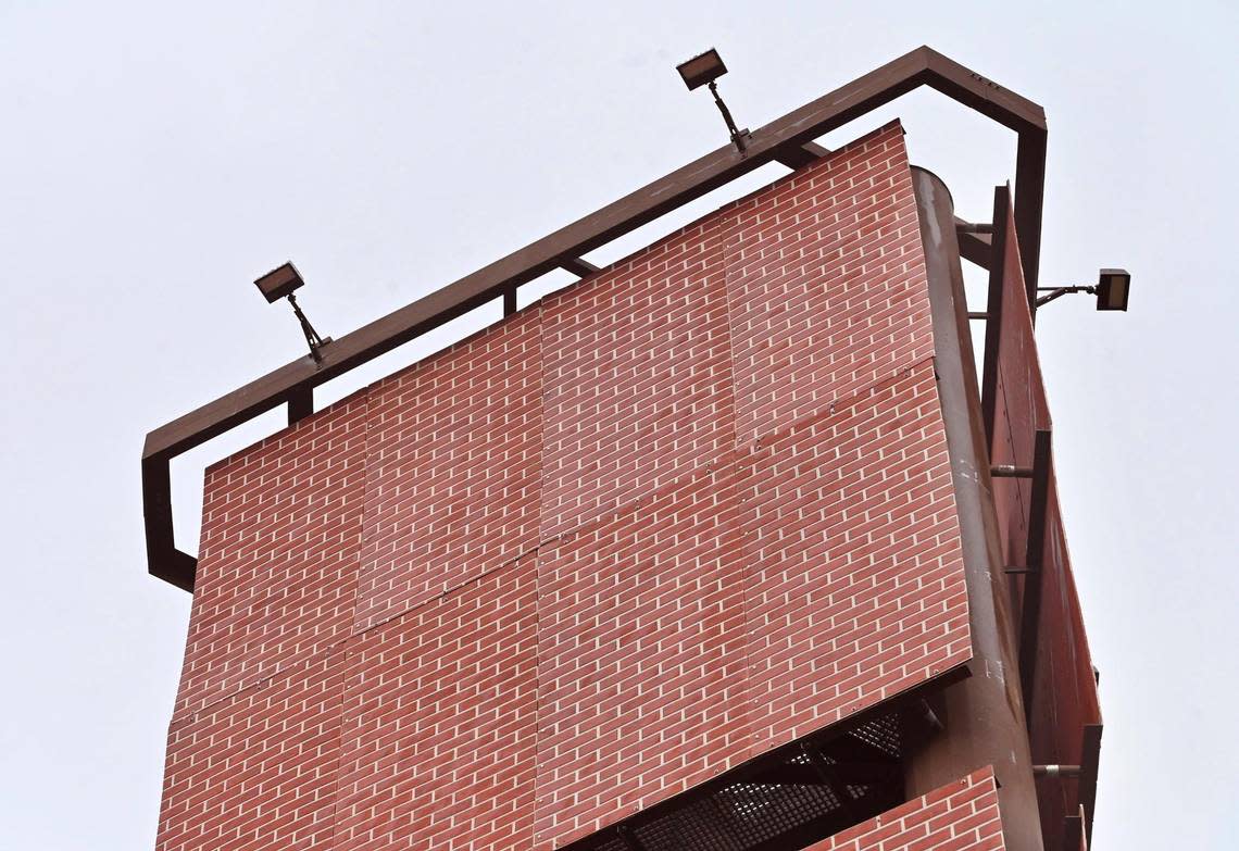 Panels of brick facade cover the Verizon cell tower at R and Ventura streets, seen Friday, March 1, 2024 in downtown Fresno. The tower, which is adjacent to the State Route 41 freeway and highly visible, was originally to resemble an artificial tree.