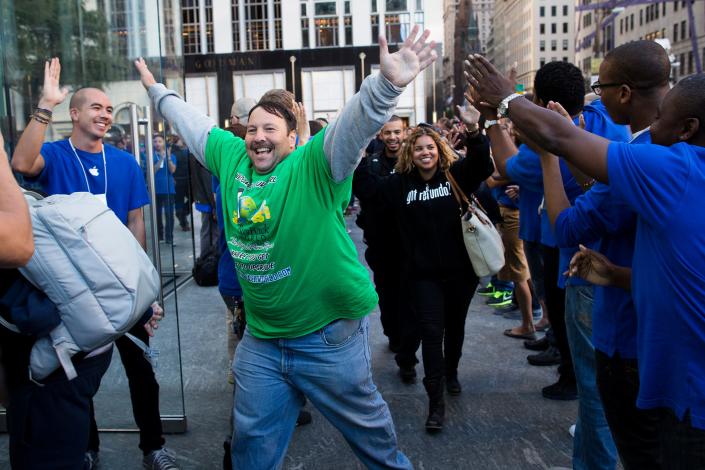 Greg Packer, 49, celebrates as he enters the Fifth Avenue Apple store for the release of the iPhone 5, Friday, Sept. 21, 2012, in New York.