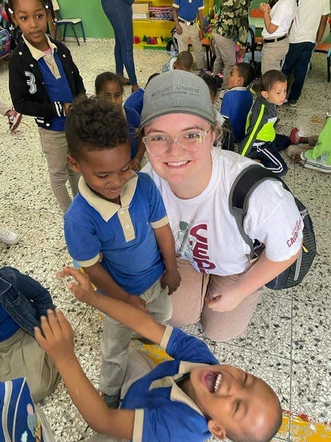 Mount Union student Kaylee Adkins (wearing hat) enjoyed her time at a school with children in the Dominican Republic. Students in Mount Union's Social Responsibility course visited Cambita Garabitos to work in the community with the town's residents.