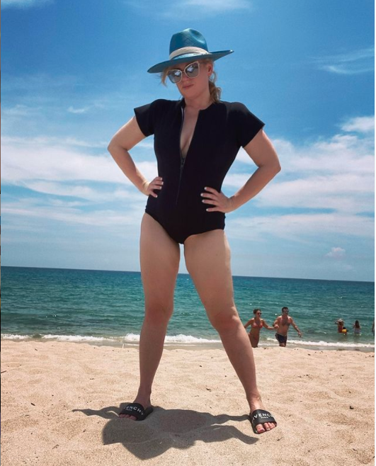 Rebel Wilson in a swimsuit on the beach