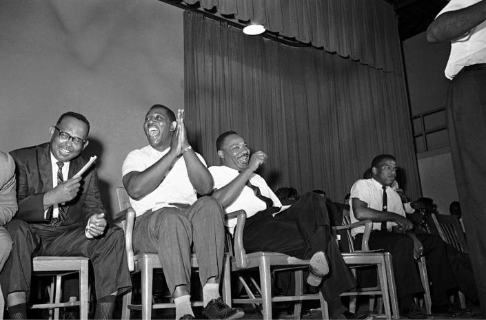 <p>Dr. Martin Luther King Jr. right, and Charles Evers, Miss. NAACP field secretary, enjoy laugh during fund raising time at mass rally in Jackson, Mississippi on July 22, 1964. (AP Photo/Jim Bourdier) </p>