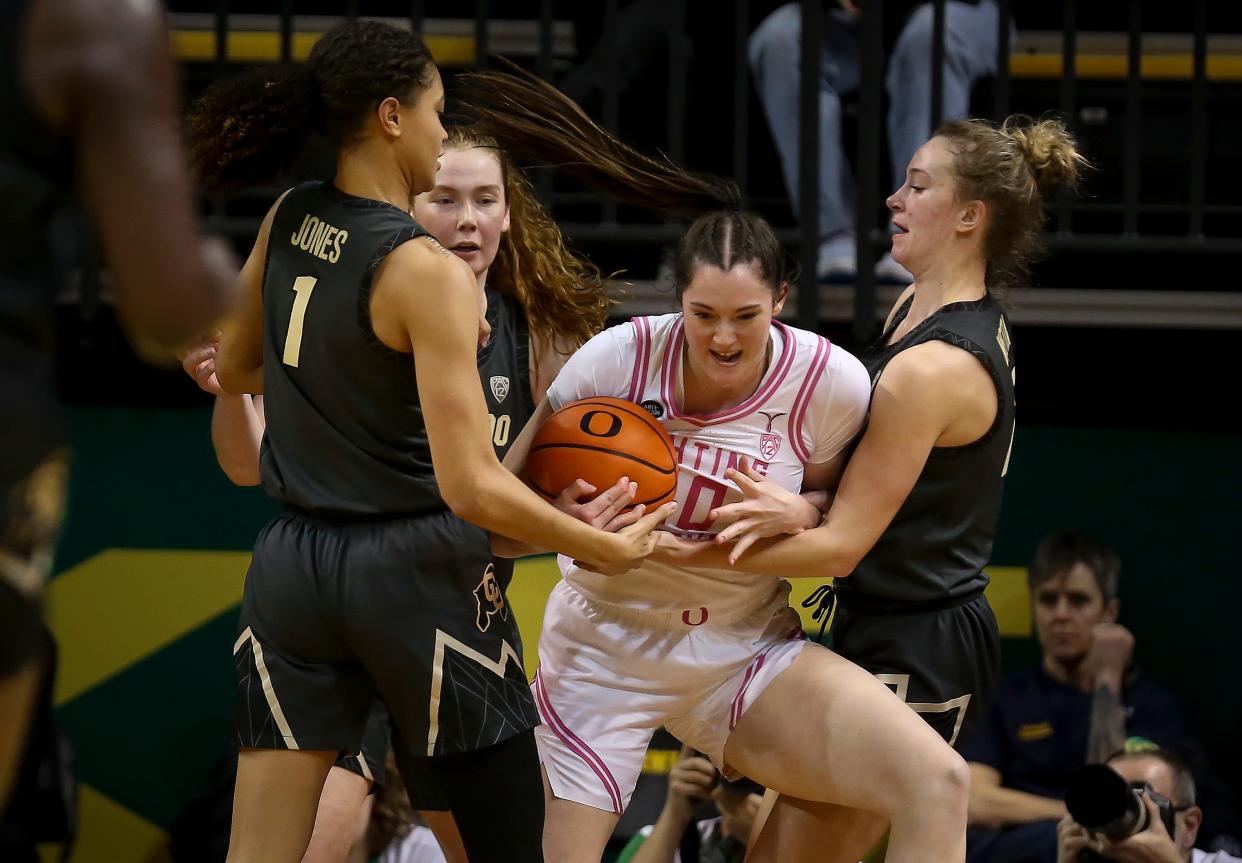 Oregon forward Grace VanSlooten struggles for control of the ball as the Oregon Ducks host the Colorado Buffaloes Friday, Feb. 3, 2023 at Matthew Knight Arena in Eugene, Ore. 