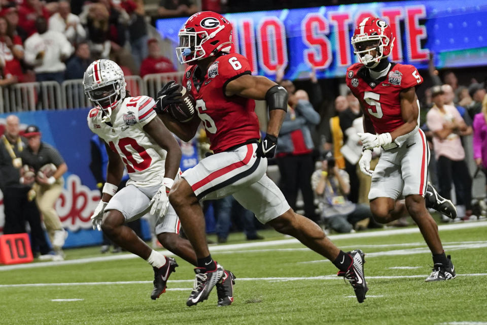 Georgia running back Kenny McIntosh (6) runs to the end zone for a touchdown against Ohio State during the first half of the Peach Bowl NCAA college football semifinal playoff game, Saturday, Dec. 31, 2022, in Atlanta. (AP Photo/Brynn Anderson)