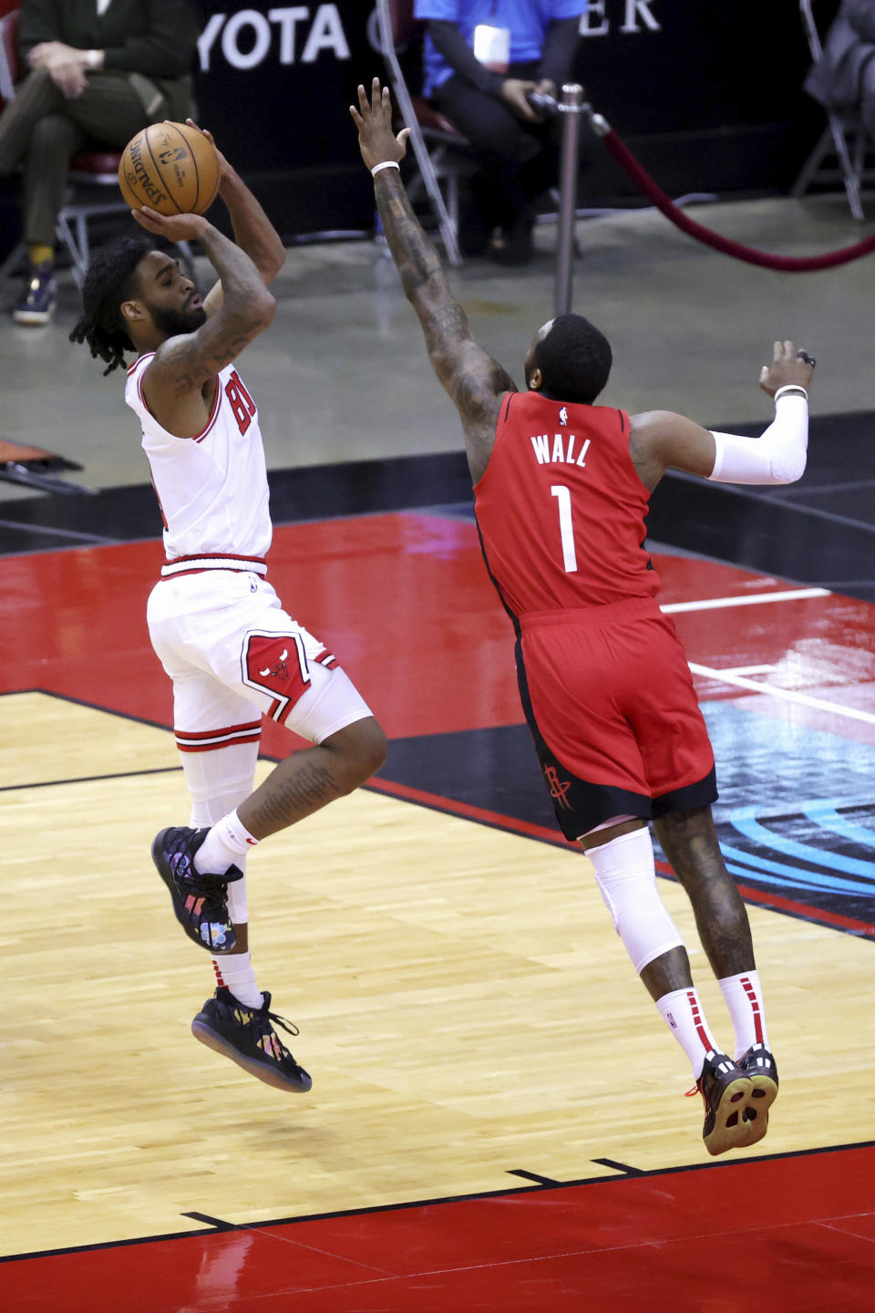 chicago Bulls' Coby White, left, puts up a jump shot ahead of Houston Rockets' John Wall (1) during the first quarter of an NBA basketball game Monday, Feb. 22, 2021, in Houston. (Carmen Mandato/Pool Photo via AP)of an NBA basketball game Monday, Feb. 22, 2021, in Houston. (Carmen Mandato/Pool Photo via AP)