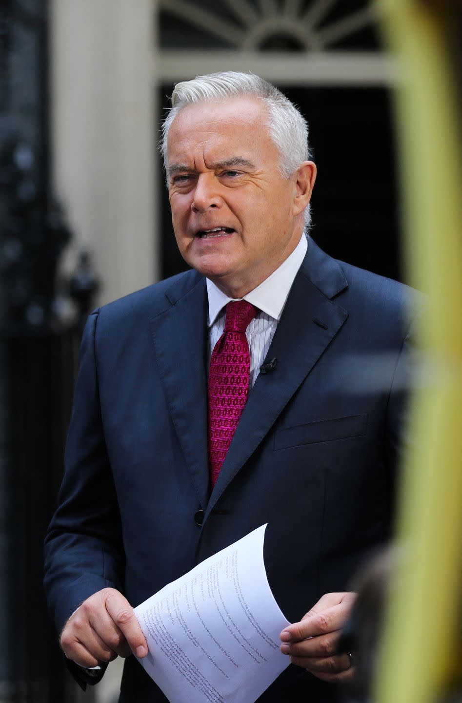 bbc journalist huw edwards speaks in front of a camera in downing street