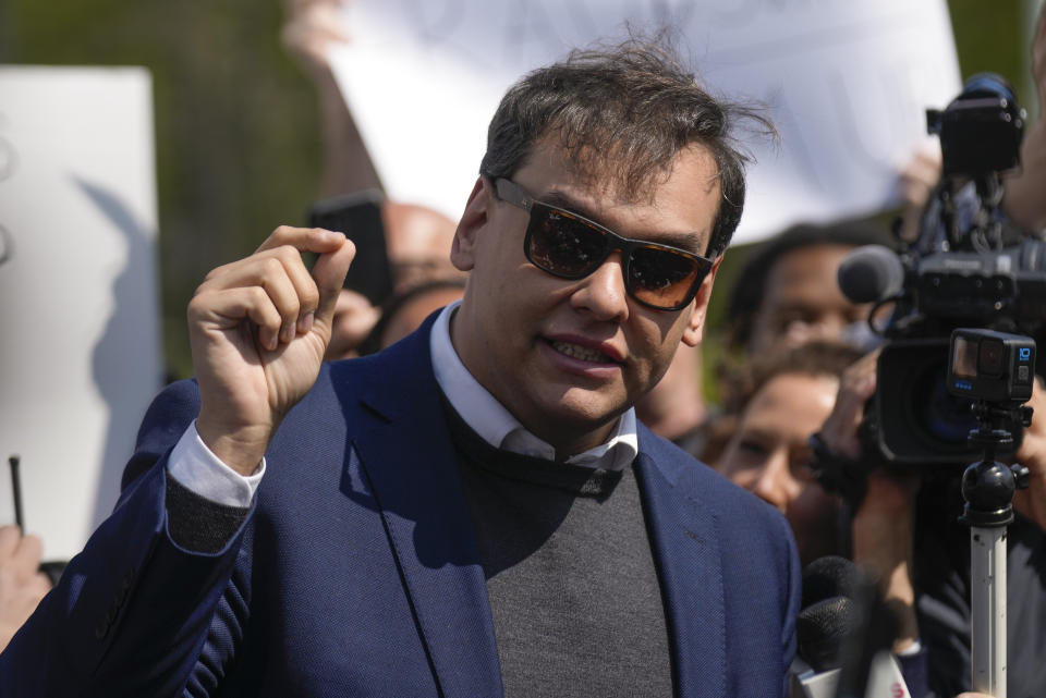 U.S. Rep. George Santos, R-N.Y., speaks to the media outside the federal courthouse in Central Islip, N.Y., Wednesday May 10, 2023. On Friday, May 12, The Associated Press reported on stories circulating online incorrectly claiming an image of Santos in a gray sweater and blue jacket is a mugshot taken Wednesday after he was indicted on federal charges.(AP Photo/Seth Wenig)