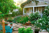 <p> If you’re partial to a front yard that’s dramatic and whimsical in equal measure, these front yard cottage garden ideas from Grace Design Associates provide the best of both worlds.  </p> <p> The wild array of flowers and stone walkway are reminiscent of a charming, modern-day fairytale. However, the greens on the roof offer a touch of drama, making this front yard look great from all angles. </p>