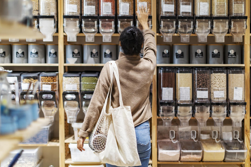 a woman reaching for something in a grocery store