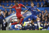 Liverpool's Georginio Wijnaldum, left, and Chelsea's Cesar Azpilicueta compete for the ball during the British premier League soccer match between Chelsea and Liverpool, at the Stamford Bridge Stadium, London, Sunday, Sept. 22, 2019. (AP Photo/Matt Dunham)