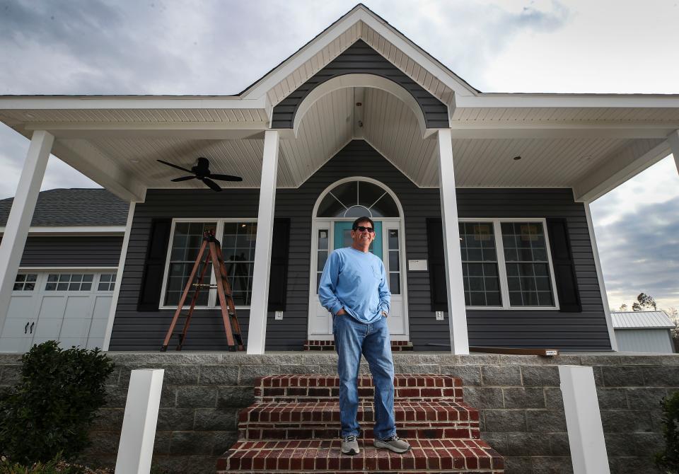 Robert Freeman stands on the porch of his replacement home being built. Freeman and his wife lost their home in the December 2021 tornados that ripped through Western Kentucky. The couple moved into their original home in 2019. Freeman said the replacement cost was around $175,000 more than his original home due to material shortages and labor. Some of Freeman's neighbors are rebuilding; a few others are not. Nov. 16, 2022.