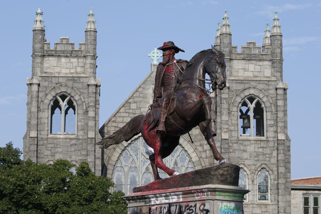 The statue of Confederate General J.E.B. Stuart is covered in graffiti on Monument Avenue on Monday July 6, 2020, in Richmond, Va. The statue is one of several slated for removal by the city of Richmond.