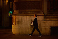 A pedestrian walks through the City of London, Britain October 18, 2017. Picture taken October 18, 2017. REUTERS/Mary Turner