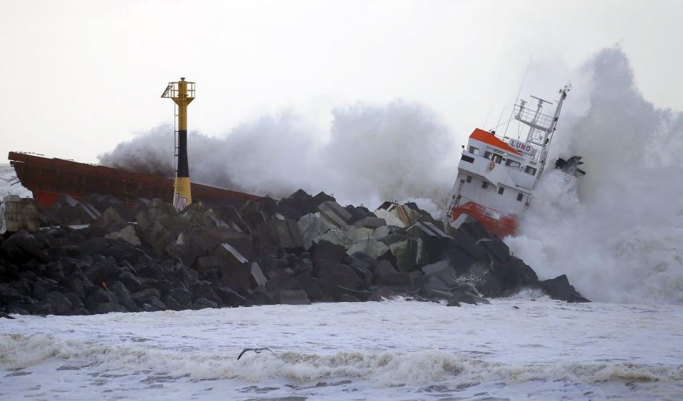 Waves are seen breaking against an empty Spanish cargo ship which broke in two on a seawall off the beach in Anglet on the Atlantic Coast of France