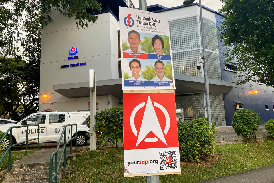 Election posters from the People’s Action Party and Singapore Democratic Party seen hanging in the Bukit Timah area. Both parties will be facing off in the electoral fight for Holland-Bukit Timah GRC. (PHOTO: Dhany Osman / Yahoo News Singapore)