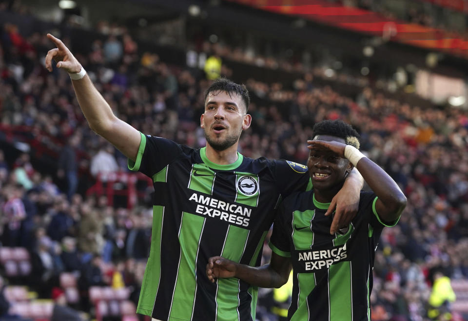 Brighton's Simon Adingra, right, celebrates with Jakub Moder after scoring his side's fifth goal during the English Premier League soccer match between Sheffield United and Brighton and Hove Albion at Bramall Lane stadium, Sheffield, England, Sunday, Feb. 18, 2024. (Nick Potts/PA via AP)