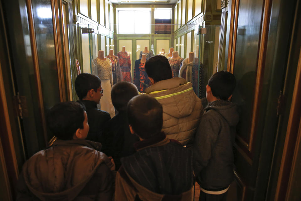 In this Tuesday, Jan. 15, 2019 photo, schoolboys visit Niavaran Palace, now a museum, that was the primary and last residence of late Shah Mohammad Reza Pahlavi and his family prior to leaving Iran for exile during the 1979 Islamic Revolution, in northern Tehran, Iran. The palace complex of mansions on a 27-acre plot, nestled against the Alborz Mountains, now welcomes the public to marvel at the luxuries the shah enjoyed as Iran's monarch for nearly four decades. It costs about $1 to enter. (AP Photo/Vahid Salemi)