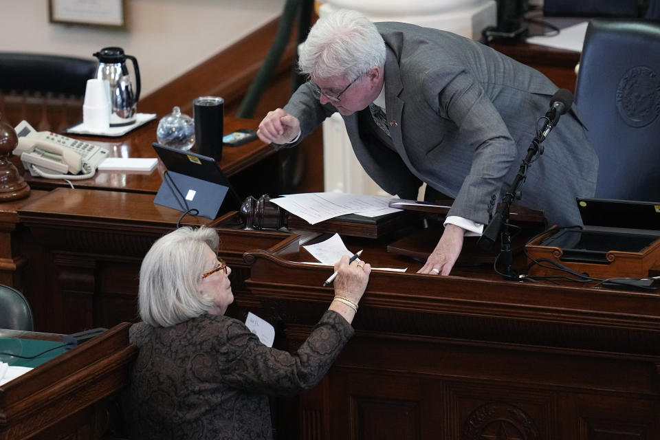 Whistleblowers David Maxwell, former director of law enforcement for the Texas Lt. Gov. Dan Patrick, right, talks with Secretary of the Senate Patsy Spaw as state senators acting as jurors vote in the impeachment trial for suspended Texas Attorney General Ken Paxton in the Senate Chamber at the Texas Capitol, Saturday, Sept. 16, 2023, in Austin, Texas. (AP Photo/Eric Gay)