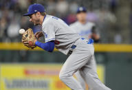 Los Angeles Dodgers shortstop Trea Turner bobbles a ground ball that was ruled a single off the bat of Colorado Rockies' Garrett Hampson in the fourth inning of a baseball game Tuesday, Sept. 21, 2021, in Denver. (AP Photo/David Zalubowski)