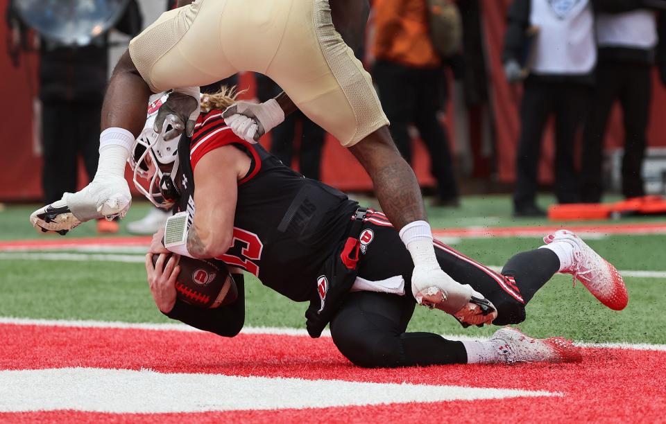 Utah Utes quarterback Luke Bottari (15) scores a touchdown on Nov. 25, 2023.