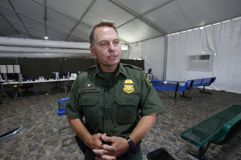 U.S. Border Patrol Chief Patrol Agent Yuma Sector, Anthony Porvaznik talks about their new 500-person tent facility during a media tour Friday, June 28, 2019, in Yuma, Ariz. The facility will be used to process detained immigrant children and families who cross the U.S. border. The Border Patrol says it will start placing families there on Friday night. (AP Photo/Ross D. Franklin)