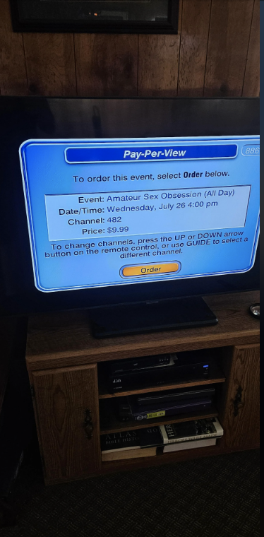 A television screen displays a Pay-Per-View menu for an event titled "Amateur Sex Obsession" priced at $9.99, scheduled for July 26