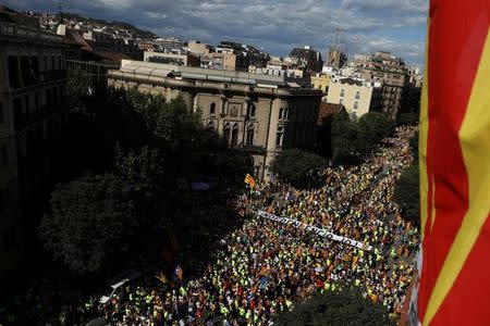 A banner reading "Independence Now" is carried as thousands of people gather for a rally on Catalonia's national day 'La Diada' in Barcelona, Spain, September 11, 2017. REUTERS/Susana Vera