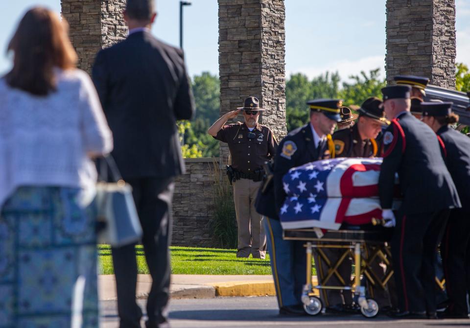 Family, military and local law enforcement stand as the late U.S. Rep. Jackie Walorski is carried in ahead of the public visitation on Wednesday, Aug. 10, 2022 at Granger Community Church. 